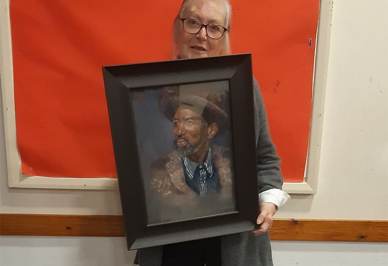 Jan Harwood with her painting "Street Musician", winner of the Margaret Carter award.